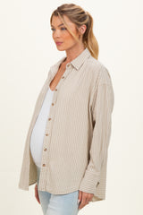 woman wearing a beige and white striped maternity button-up shirt and showing her baby bump
