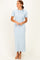 woman wearing a light blue ribbed maxi dress with short sleeves and a tie detail at the shoulder