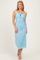 woman wearing a light blue midi dress with lace detailing and adjustable straps