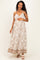 woman wearing a floral print maternity maxi dress with adjustable straps and a visible baby bump