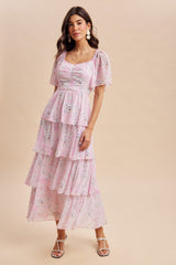 woman wearing a pink floral tiered maxi dress with puff sleeves and square neckline