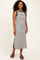 woman wearing a black and white striped sleeveless maxi dress with side slits