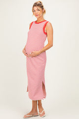woman wearing a red and white striped maternity dress with side slits, cradling her baby bump