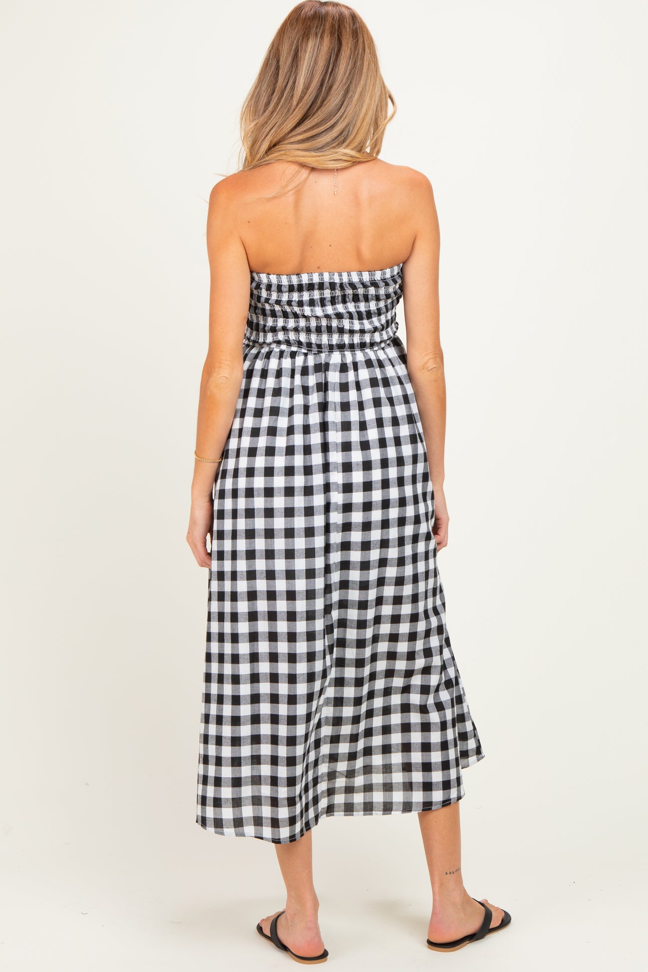 maternity wear black and white gingham strapless maxi dress with smocked bodice and flowing skirt