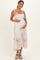 woman wearing a light floral maternity maxi dress with tie straps and holding her baby bump