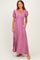 woman wearing a pink maxi dress with puff sleeves and a v-neck, featuring a white polka dot pattern and side pockets