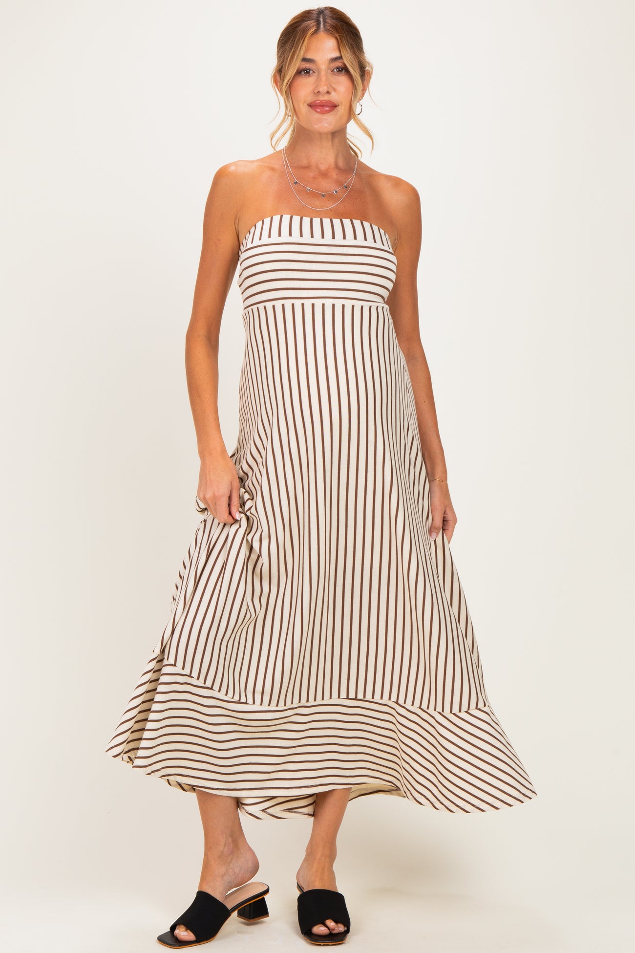 woman wearing a striped strapless maternity dress with a flowing hemline and a relaxed fit