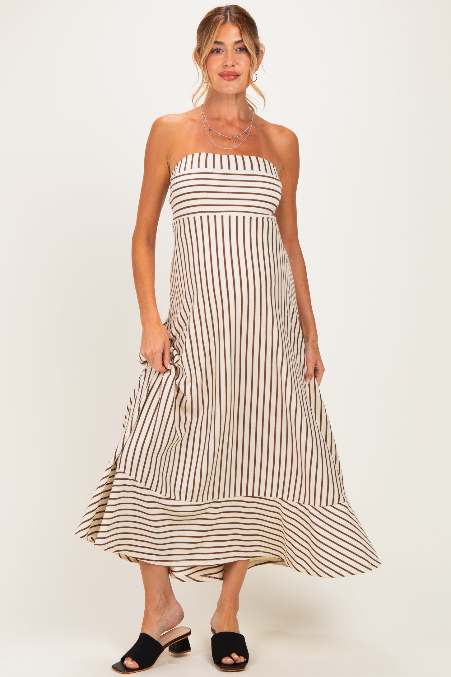 woman wearing a striped strapless maternity dress with a flowing hemline and a relaxed fit