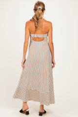 woman wearing a striped backless maternity maxi dress with a flowy hem and a comfortable fit