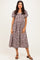 woman wearing a brown and white checkered midi dress with puff sleeves and a square neckline
