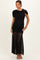 woman wearing a black maternity dress with ruching and sheer skirt, displaying her baby bump