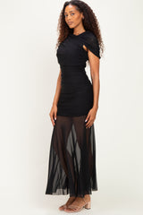 woman wearing a black ruched maxi dress with sheer skirt and cap sleeves