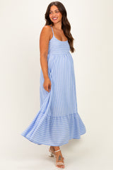 woman wearing a light blue striped maternity maxi dress with a ruffled hem and a visible baby bump