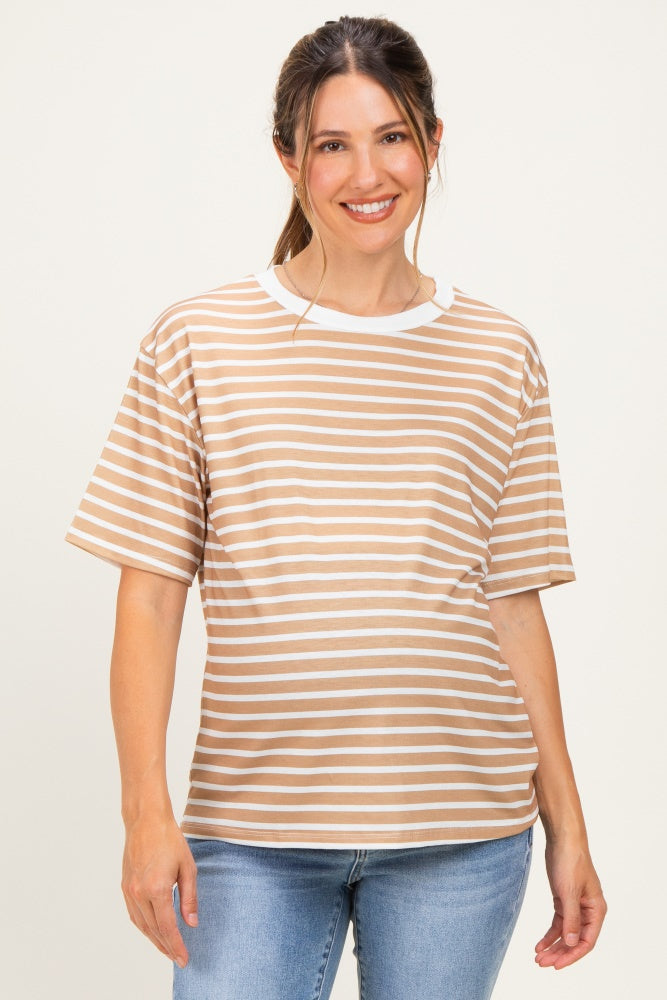woman wearing a tan and white striped maternity top with short sleeves and a relaxed fit, showing her baby bump