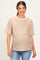 woman wearing a tan and white striped maternity top with short sleeves and a relaxed fit, showing her baby bump