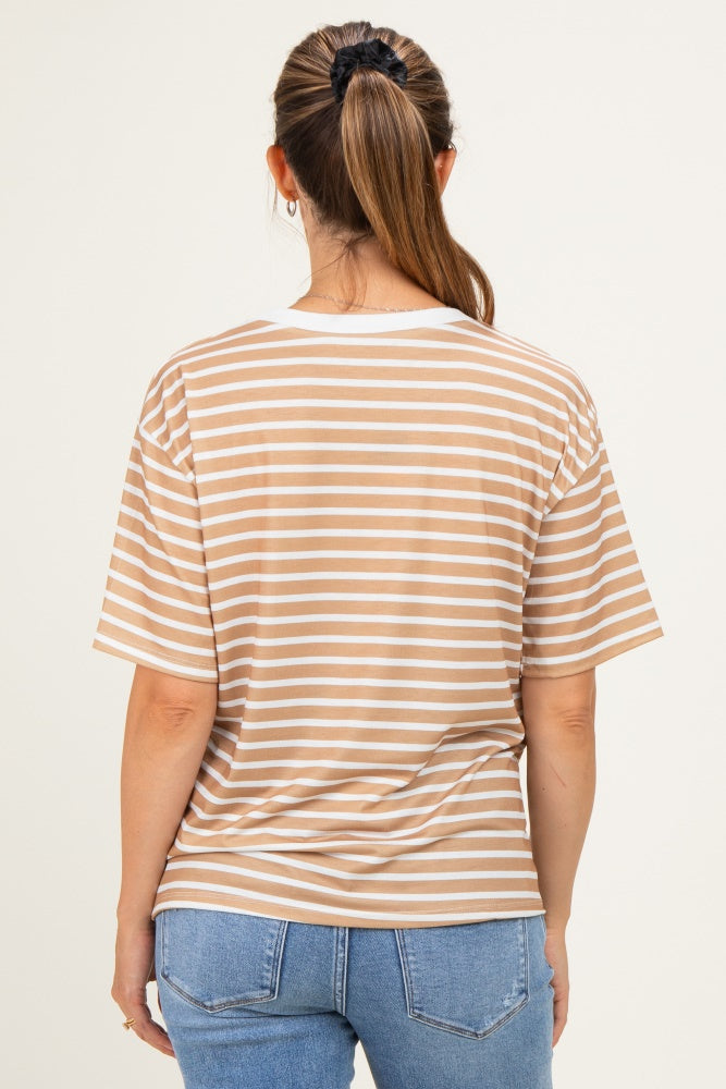 woman wearing a beige and cream striped maternity t-shirt, seen from the back, paired with blue jeans
