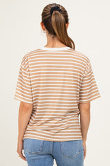 woman wearing a beige and cream striped maternity t-shirt, seen from the back, paired with blue jeans
