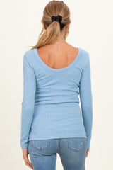 woman wearing a light blue ribbed long sleeve maternity top with a scoop back view