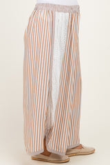 woman wearing a striped maternity maxi skirt with side slits and eyelet detailing