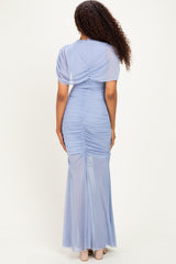 woman wearing a light blue fitted maxi dress with ruching details and short puff sleeves, viewed from the back