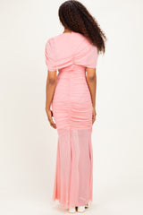 woman wearing a pink ruched maxi dress with puff sleeves, seen from the back