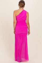 woman wearing a bright pink one-shoulder maternity gown with ruching and a flowing skirt