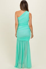 woman wearing a mint green one-shoulder maternity gown with ruched top and flowing bottom, showing a baby bump