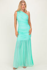 woman wearing a mint green one-shoulder evening gown with ruched details and a flowing skirt