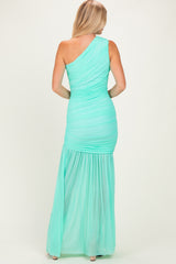 woman wearing a mint green one-shoulder evening gown with ruched detailing and a flowy skirt