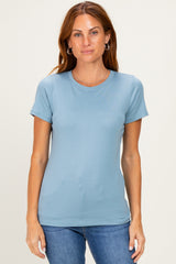 woman wearing a light blue short sleeve fitted t-shirt and blue jeans