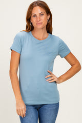 woman wearing a light blue short sleeve t-shirt with a round neckline and slightly fitted style