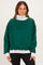woman wearing a green oversized sweatshirt with a gray mock neck and cuffed sleeves