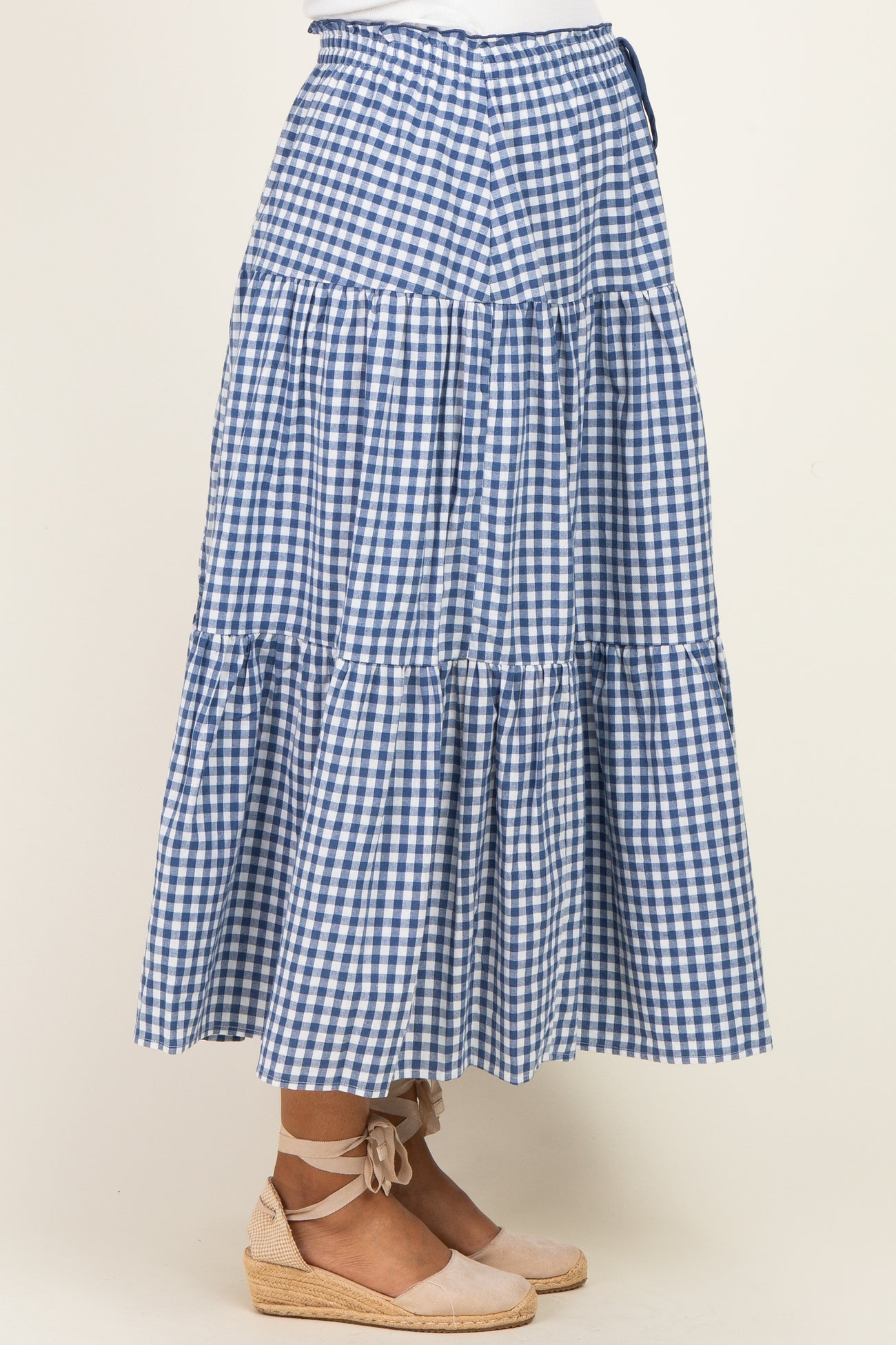 maternity wear blue and white gingham tiered maxi skirt with a tie waist detail, worn with espadrille flats