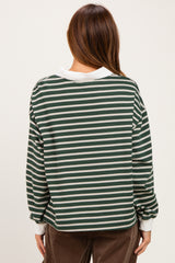 woman wearing a green and white striped long sleeve top with a relaxed fit and contrasting collar