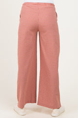 woman wearing red and white checkered maternity wide-leg pants, viewed from the back