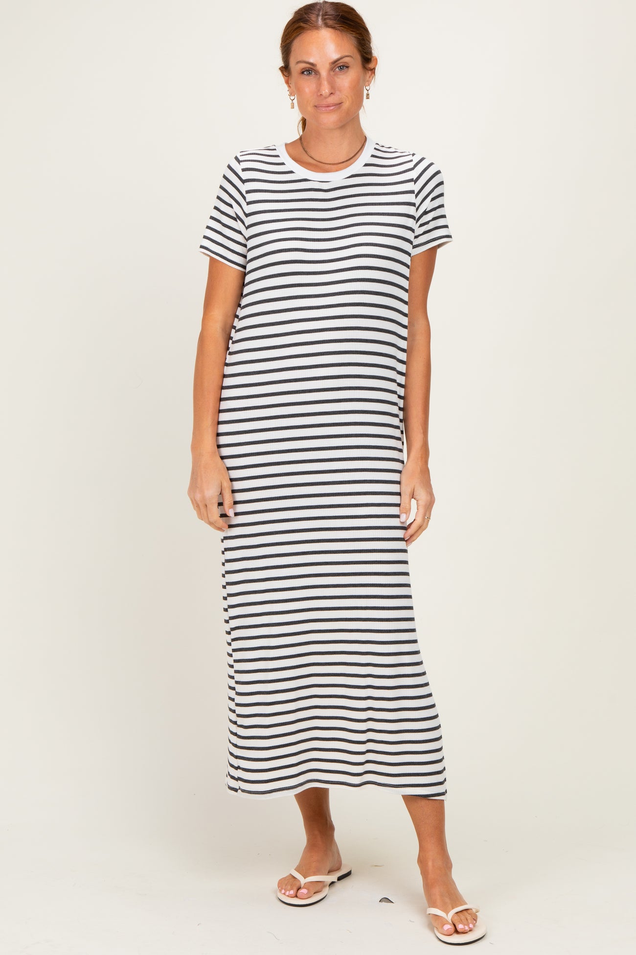 woman wearing a black and white striped short sleeve maxi dress