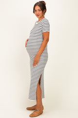 woman wearing a black and white striped maternity dress with side slits and a visible baby bump