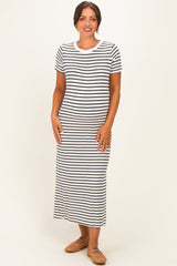woman wearing a black and white striped maternity maxi dress with a fitted silhouette and short sleeves, showing her baby bump