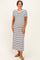 woman wearing a black and white striped maternity maxi dress with a fitted silhouette and short sleeves, showing her baby bump