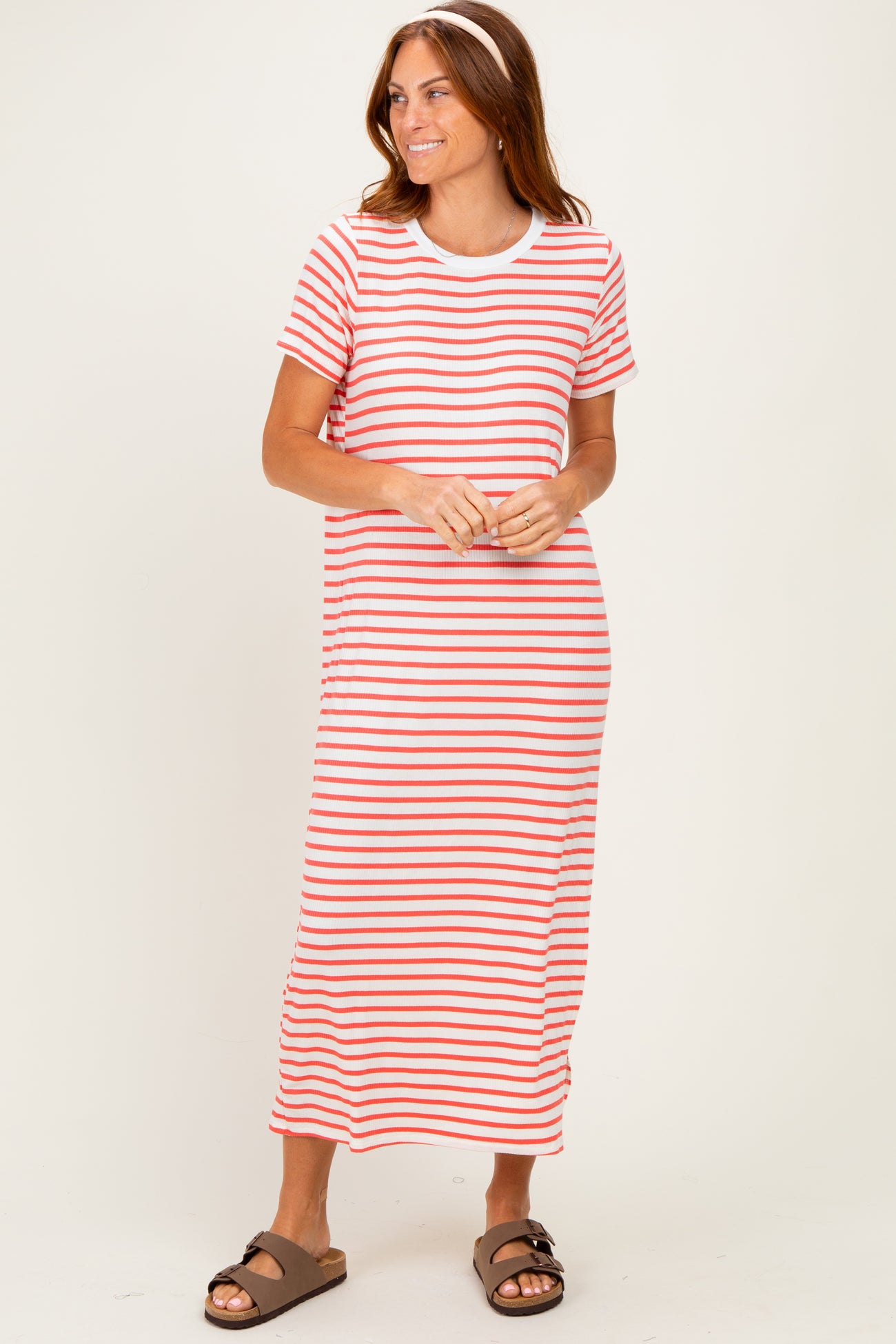 woman wearing a red and white striped short sleeve maxi dress and brown sandals