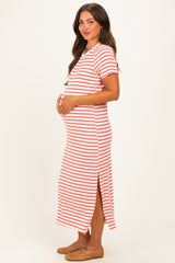 woman wearing a red and white striped maternity maxi dress and holding her baby bump