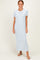 woman wearing a light blue striped maxi dress with short sleeves and standing in a neutral background