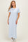 woman wearing a light blue short sleeve maxi dress paired with white sneakers