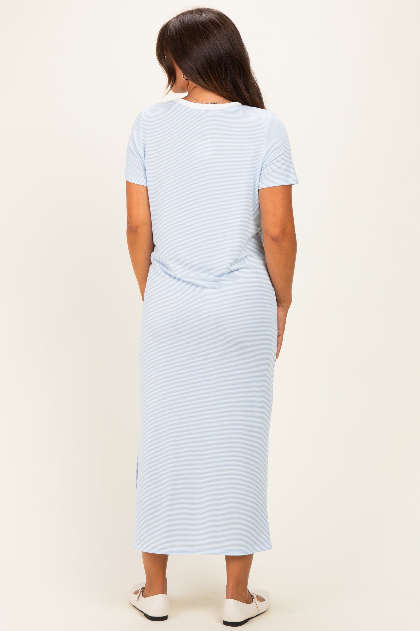 woman wearing a light blue short sleeve maternity maxi dress, viewed from the back