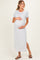 woman wearing a light gray maternity maxi dress with short sleeves and side slit, cradling her baby bump