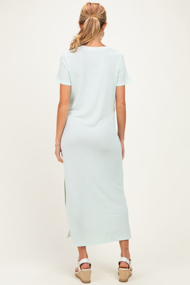 woman wearing a light green maternity maxi dress with short sleeves and side slits
