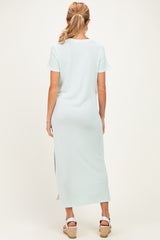 woman wearing a light green maternity maxi dress with short sleeves and side slits