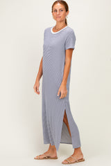 woman wearing a light gray maxi dress with short sleeves and side slits, styled with flat sandals