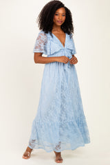 woman wearing a light blue lace maxi dress with short sleeves and a ruffled neckline