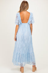 woman wearing a light blue lace maternity maxi dress with a ruffled back and short sleeves